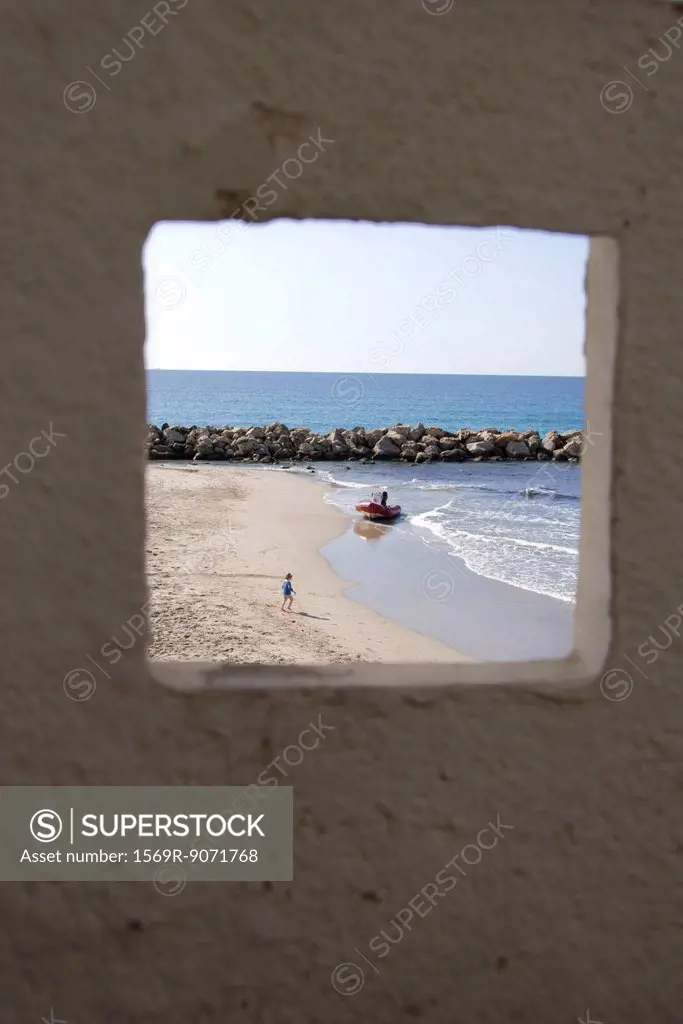 View of beach and ocean through window
