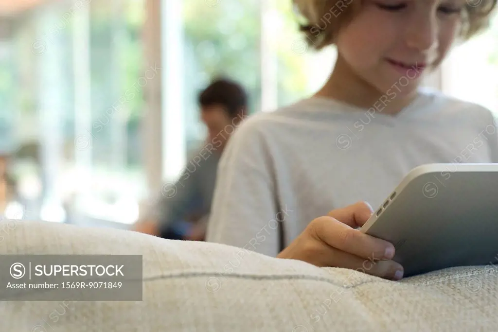 Boy holding digital tablet, selective focus
