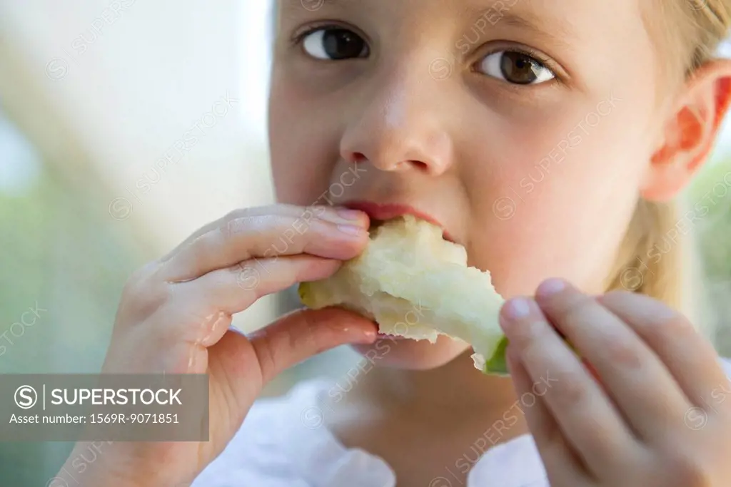 Little girl eatiing apple