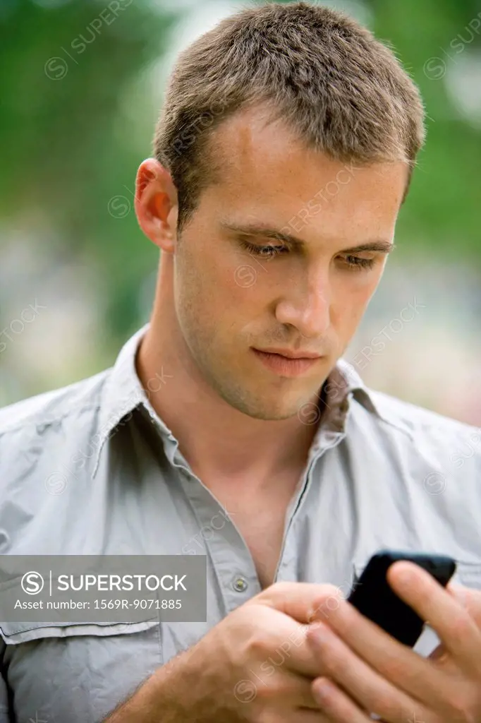 Man text messaging with cell phone