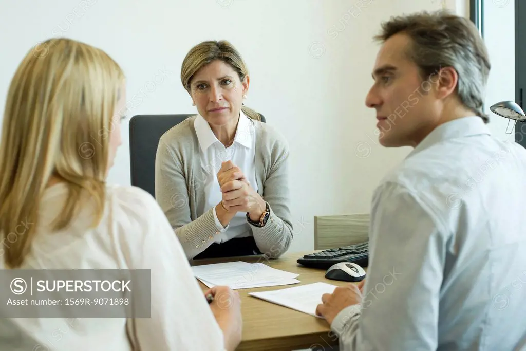 Businesswoman talking with clients in office