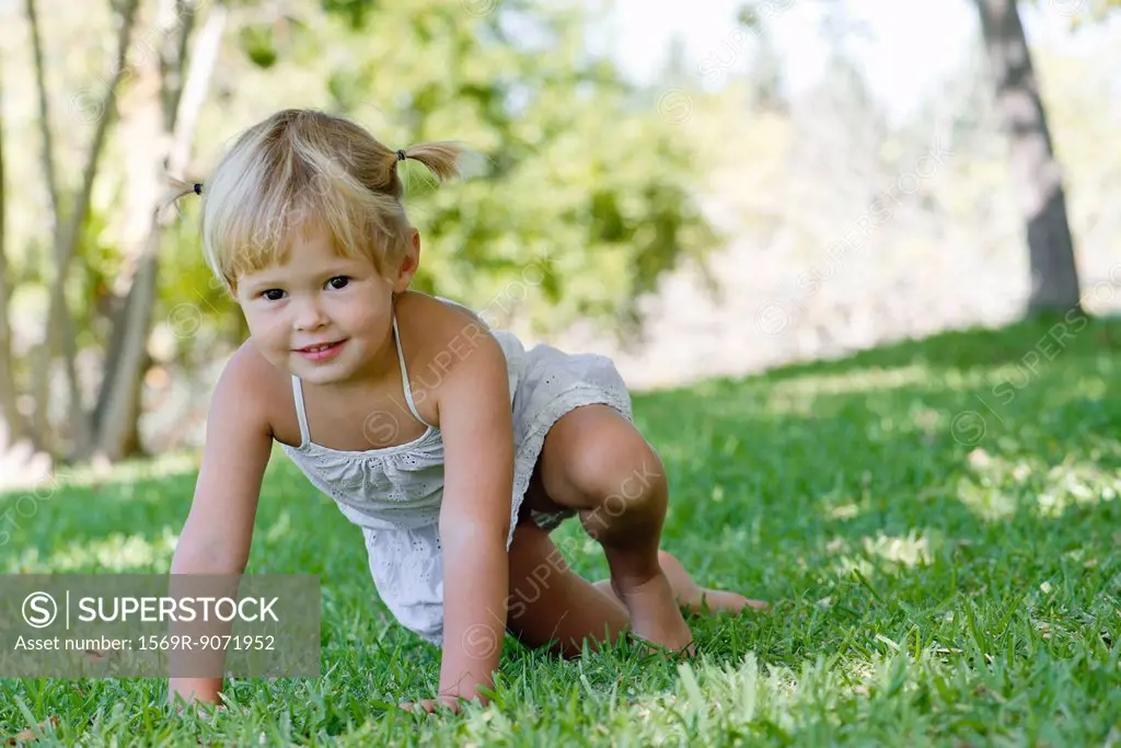 Little girl playing on grass