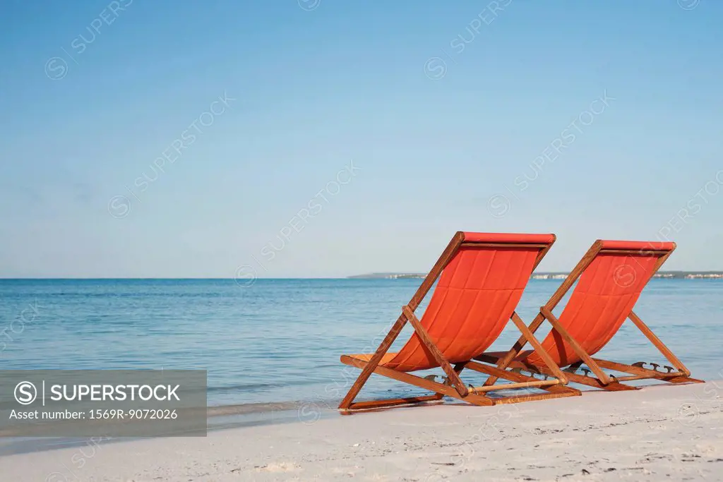 Empty deckchairs on beach