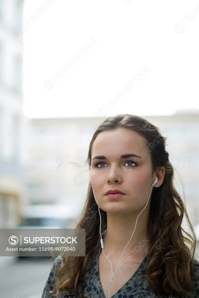 Young woman listening to music with earphones