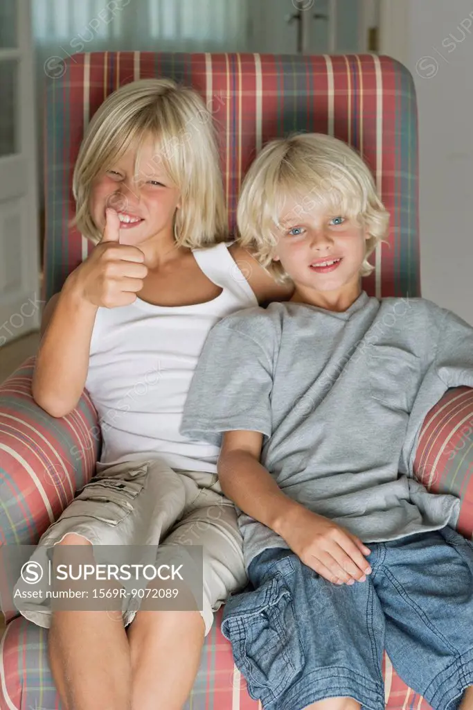 Brothers sitting in armchair, portrait