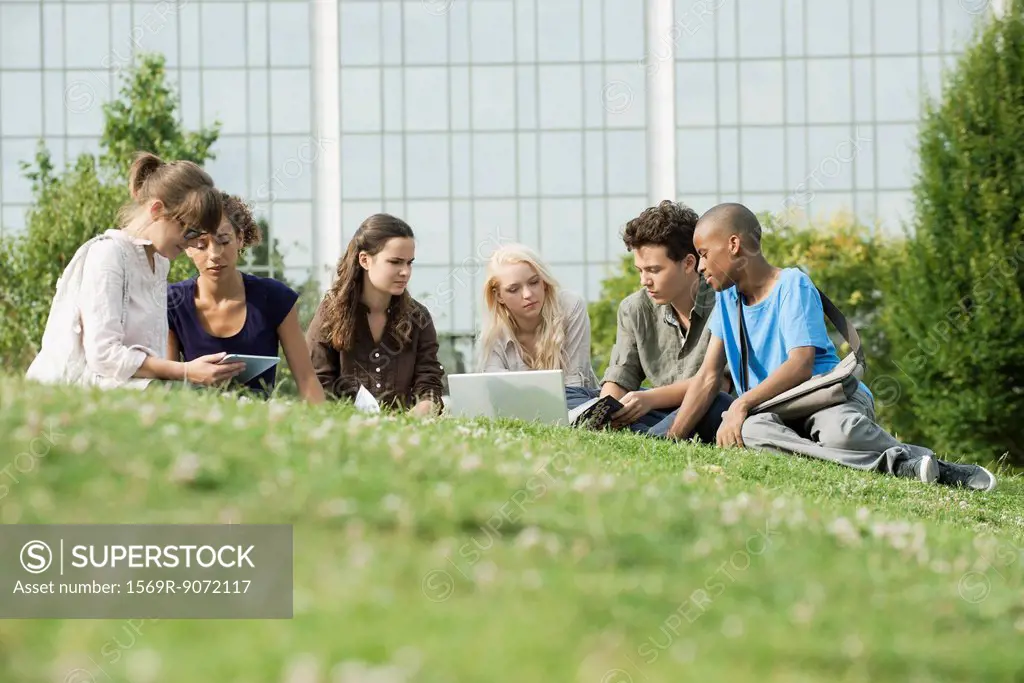 University students studying on grass, low angle veiw