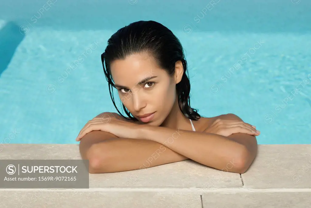 Woman relaxing in pool, portrait