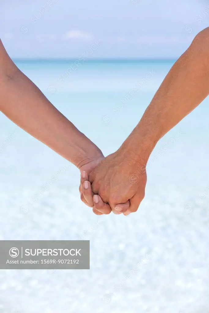 Couple holding hands, cropped