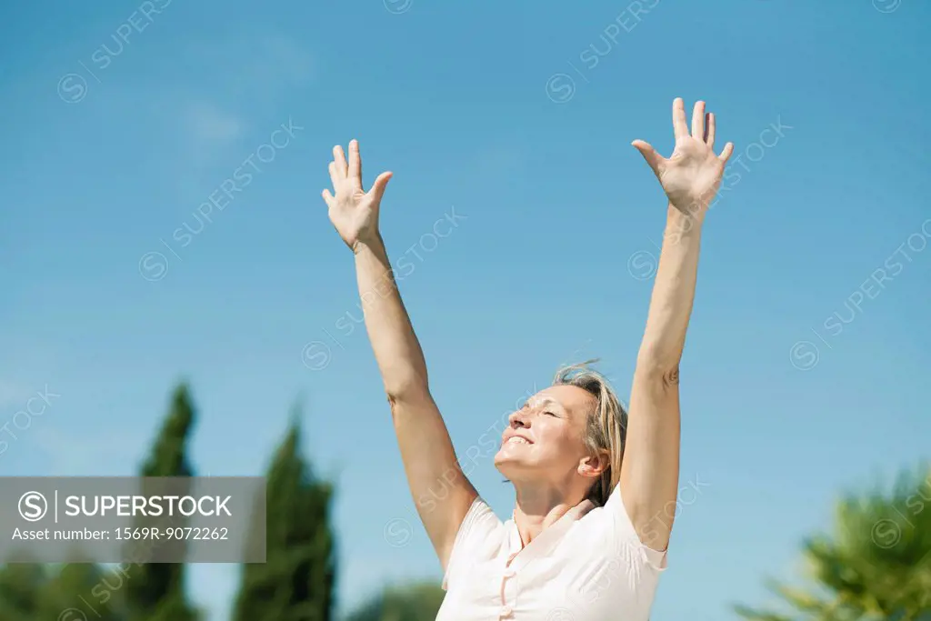 Woman in sun salutation pose outdoors