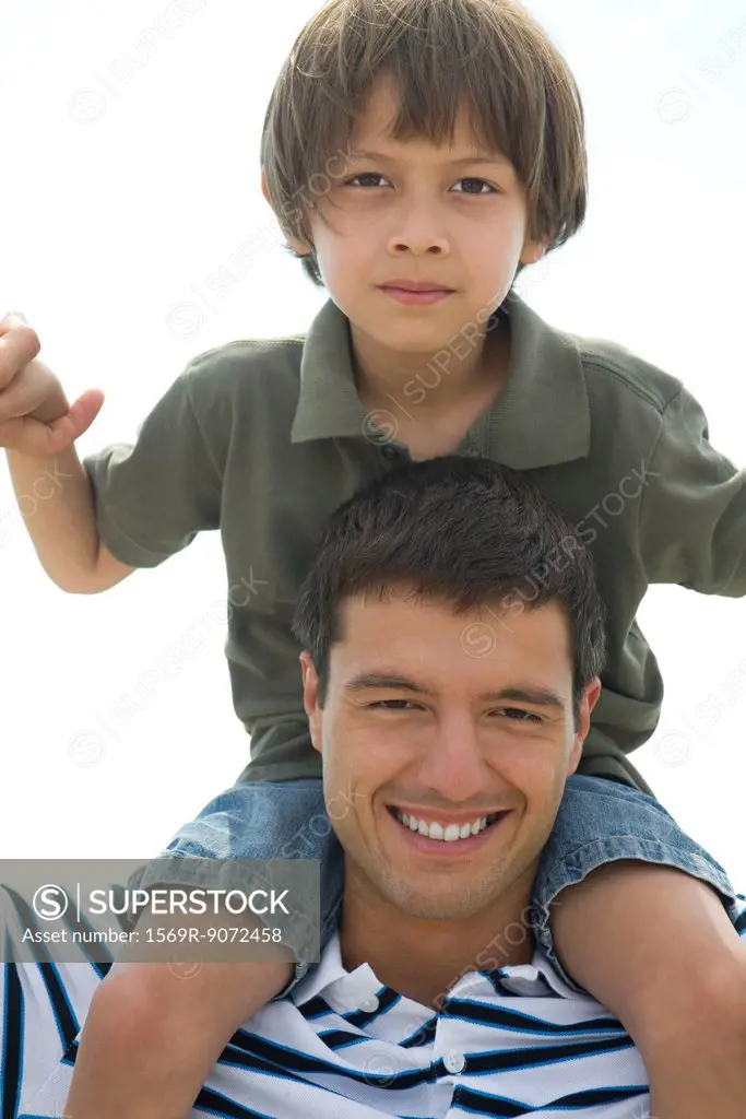 Boy riding on his father´s shoulders, portrait