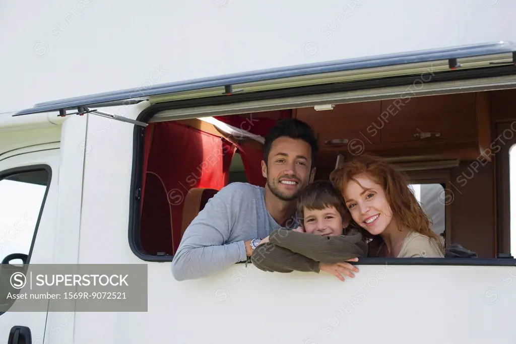Parents and young boy in motor home, portrait