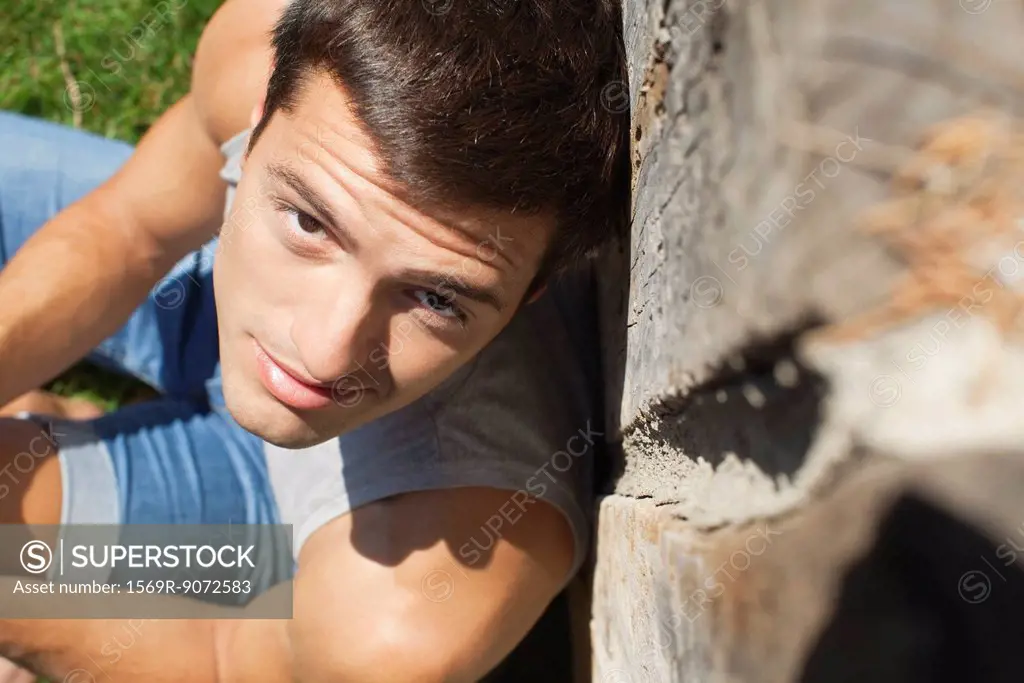 Man leaning against wall, portrait