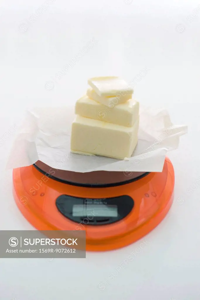 Weighing butter on kitchen scale