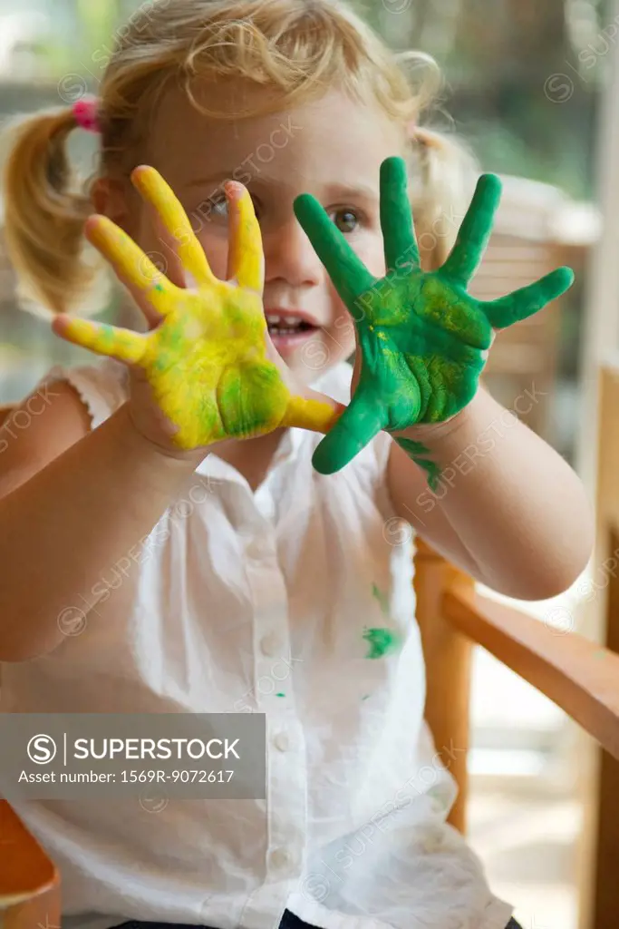 Little girl with paint on her hands