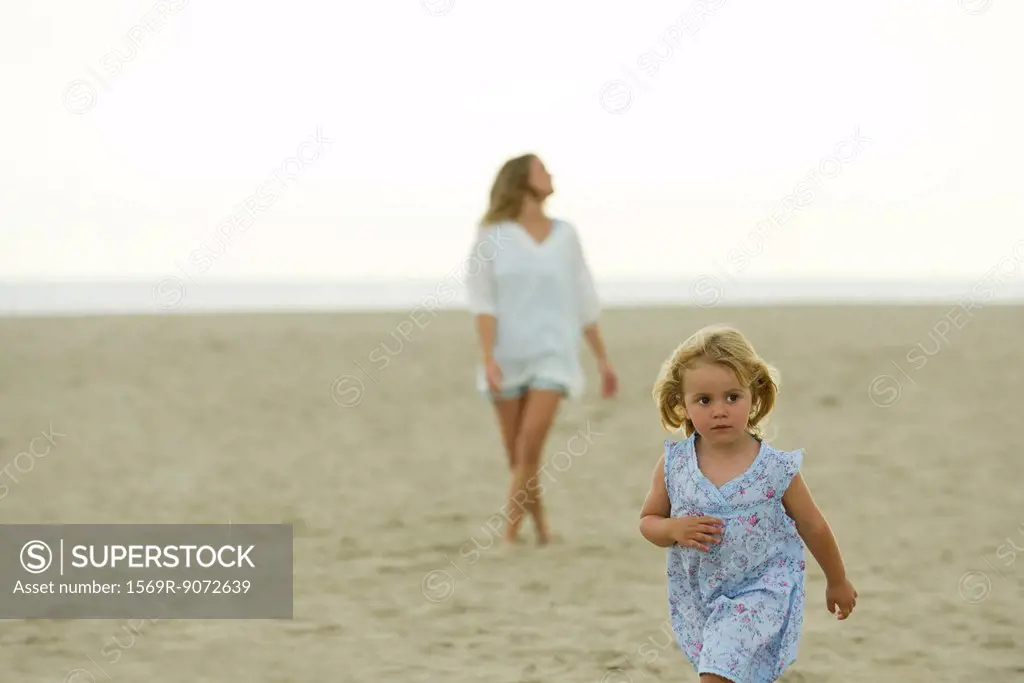 Little girl walking on beach