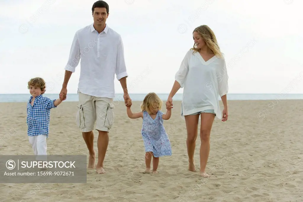 Family walking hand in hand at the beach
