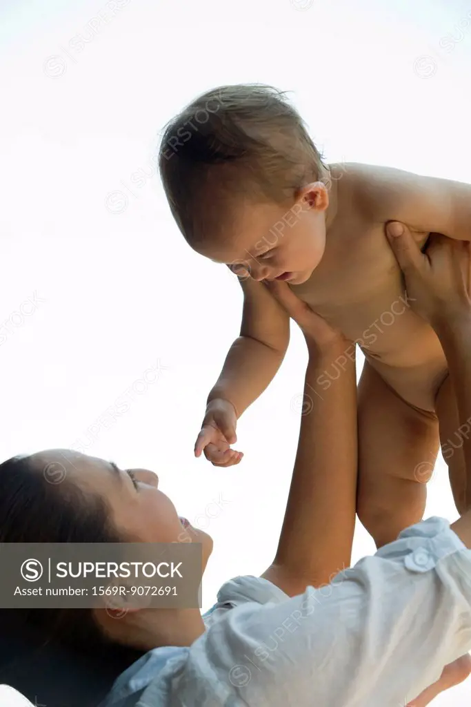 Mother lifting baby in air