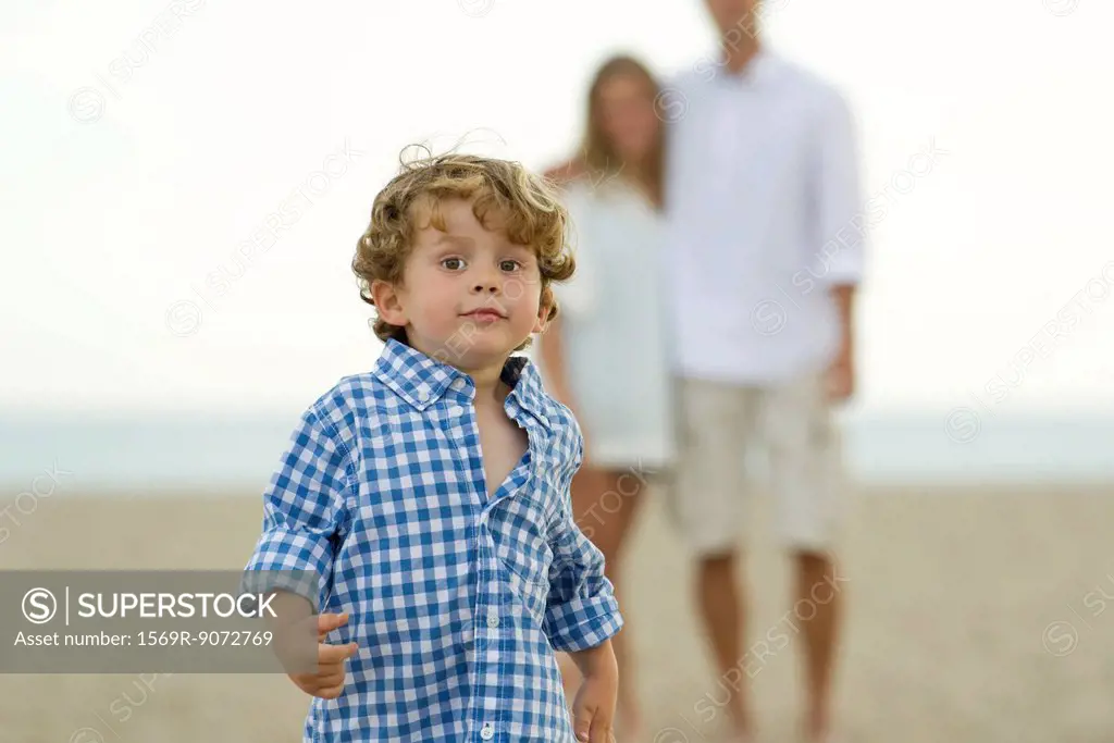 Little boy running at the beach