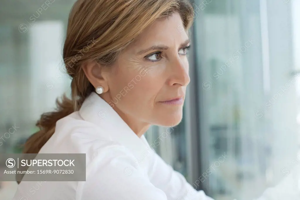 Businesswoman looking out of window