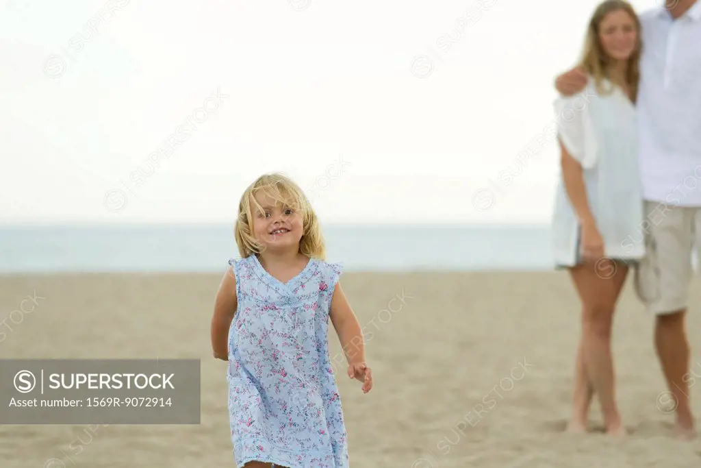 Little girl running at the beach
