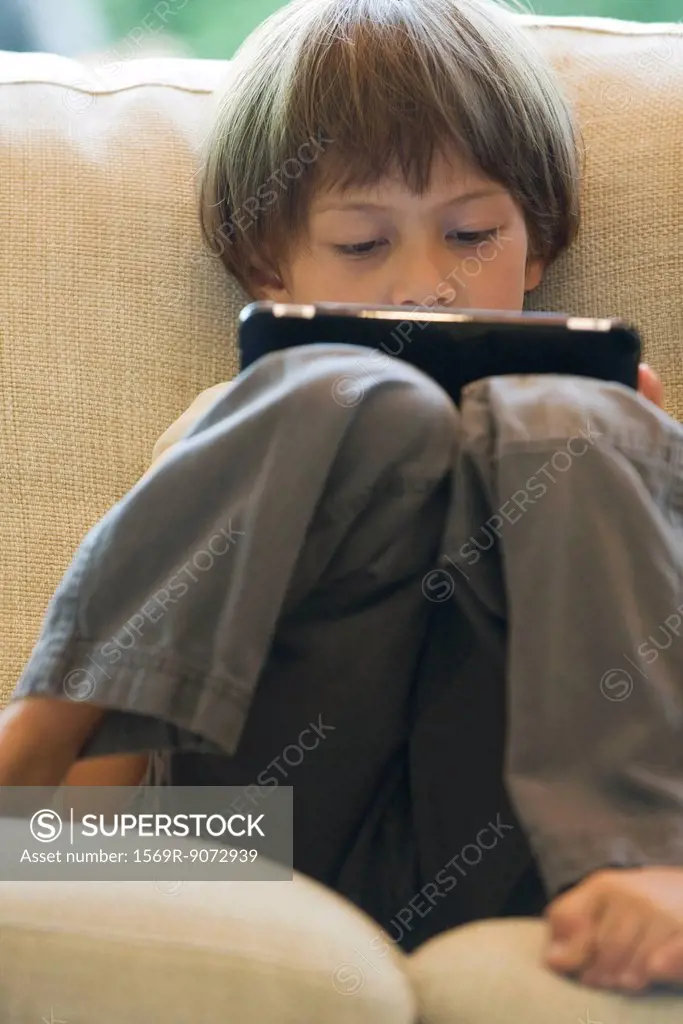 Boy using digital tablet
