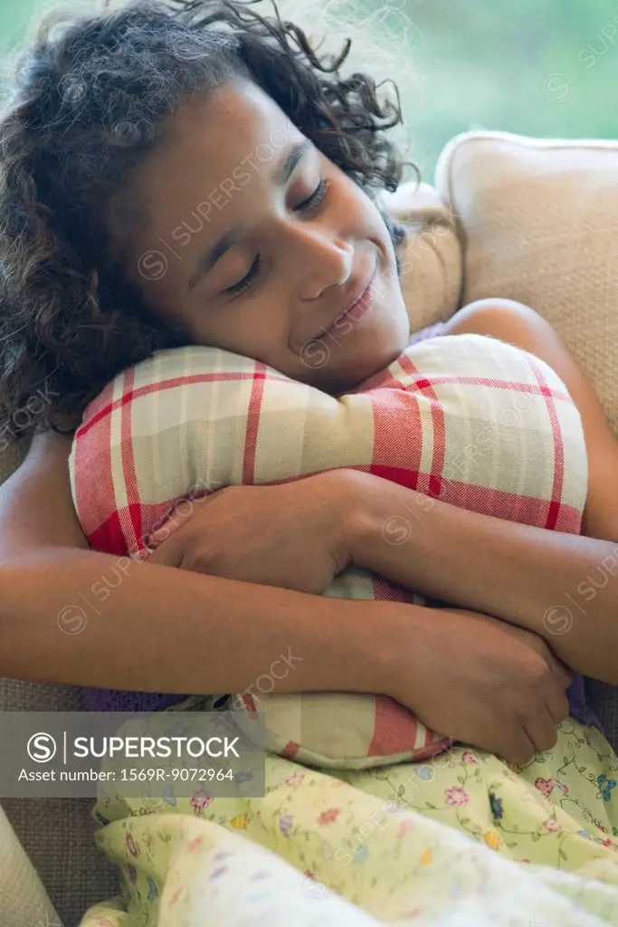 Girl hugging pillow