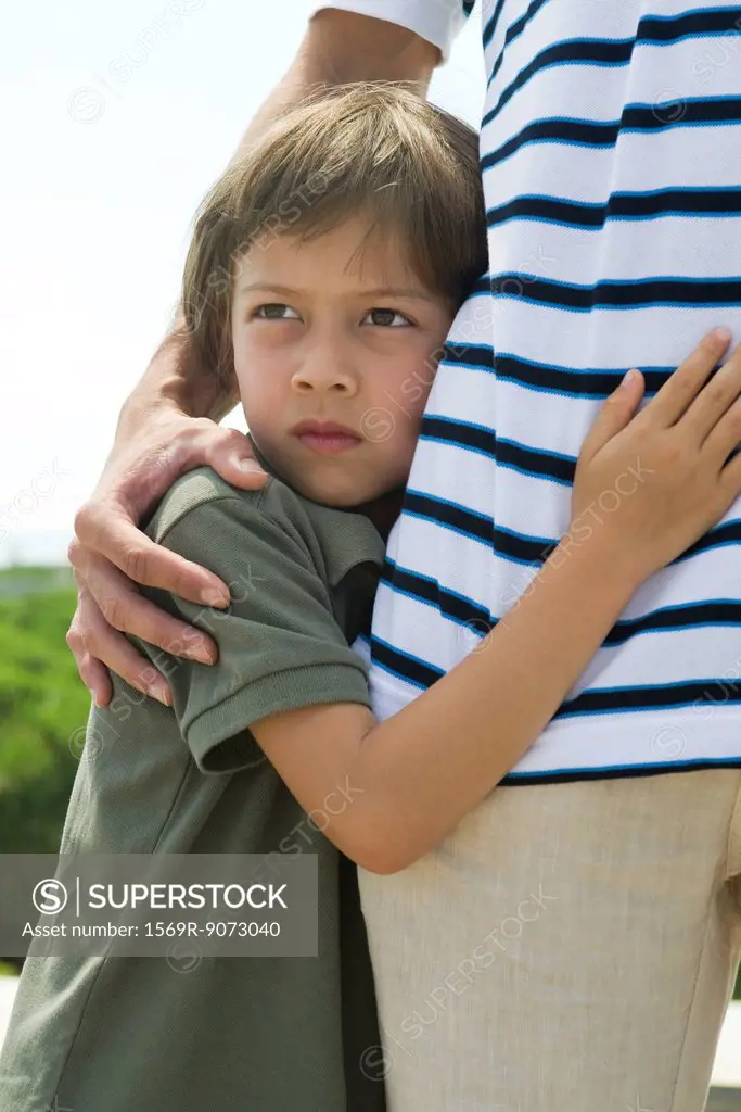 Boy embracing father, cropped