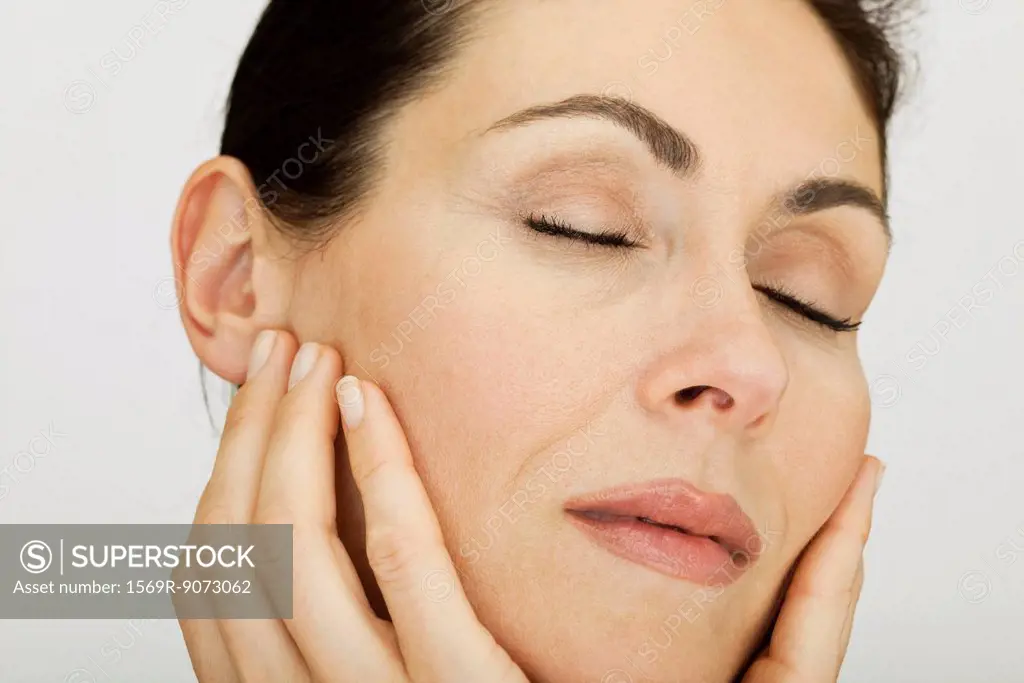 Woman feeling softness of complexion