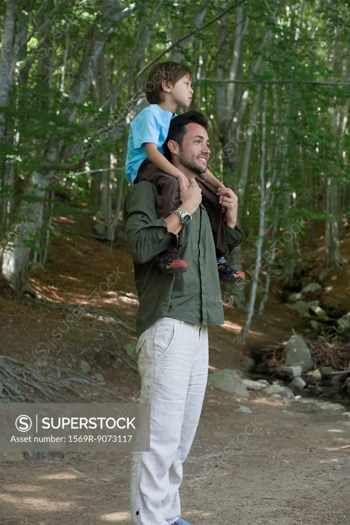 Father carrying son on shoulders