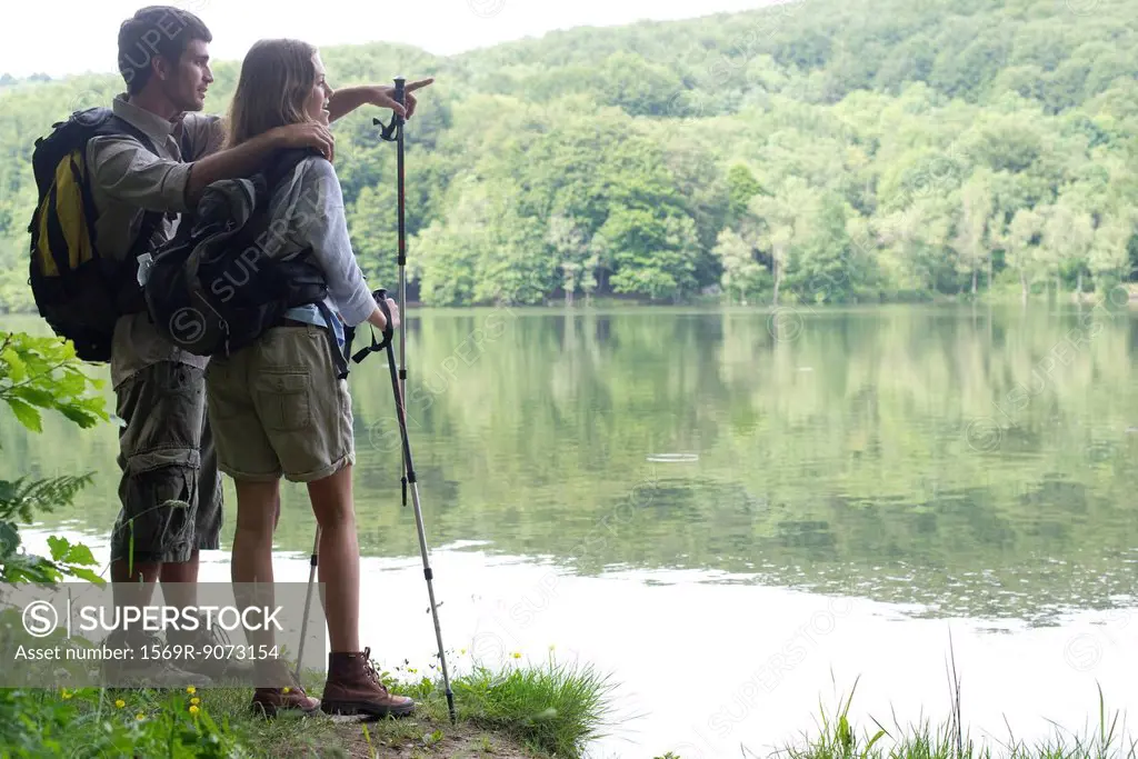 Hiking couple looking at lake