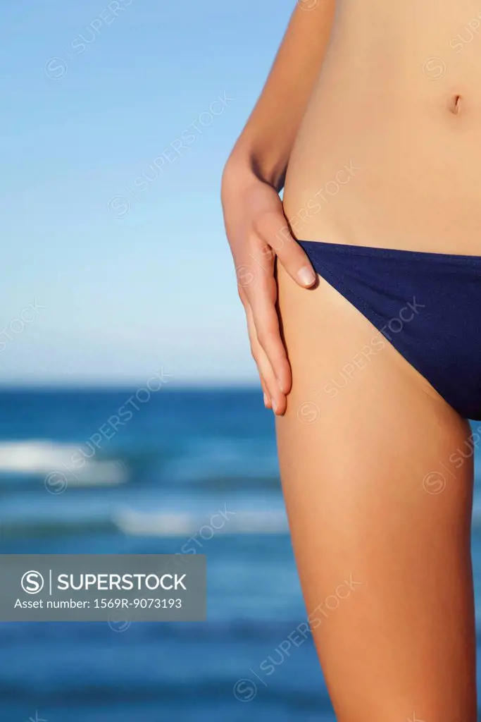 Woman in bikini bottom, mid section