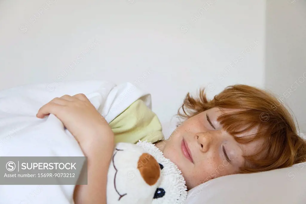 Boy sleeping in bed