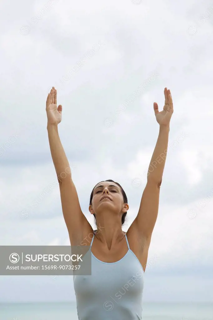 Mature woman in upward salute position