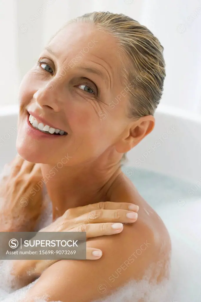 Mature woman enjoying bubble bath