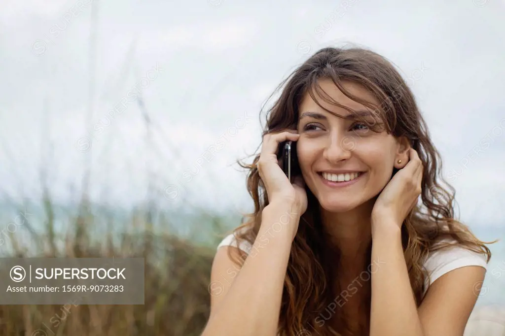 Young woman talking on cell phone, portrait
