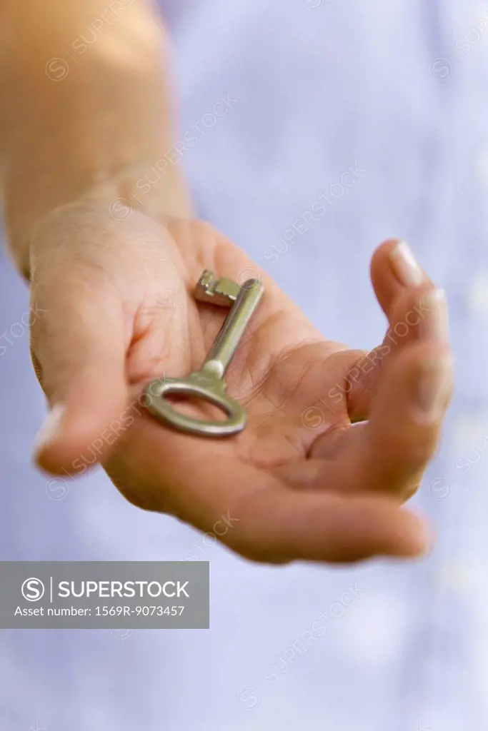 Woman holding key in palm