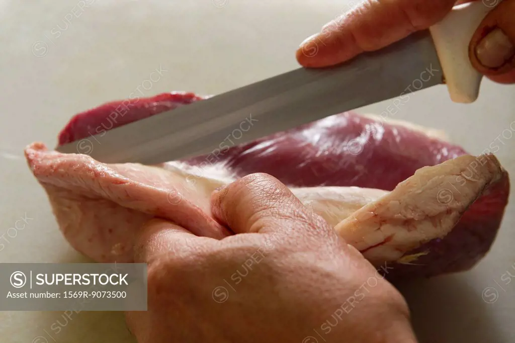 Person cutting duck breast