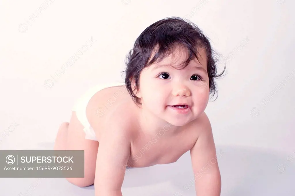 Baby girl crawling, portrait