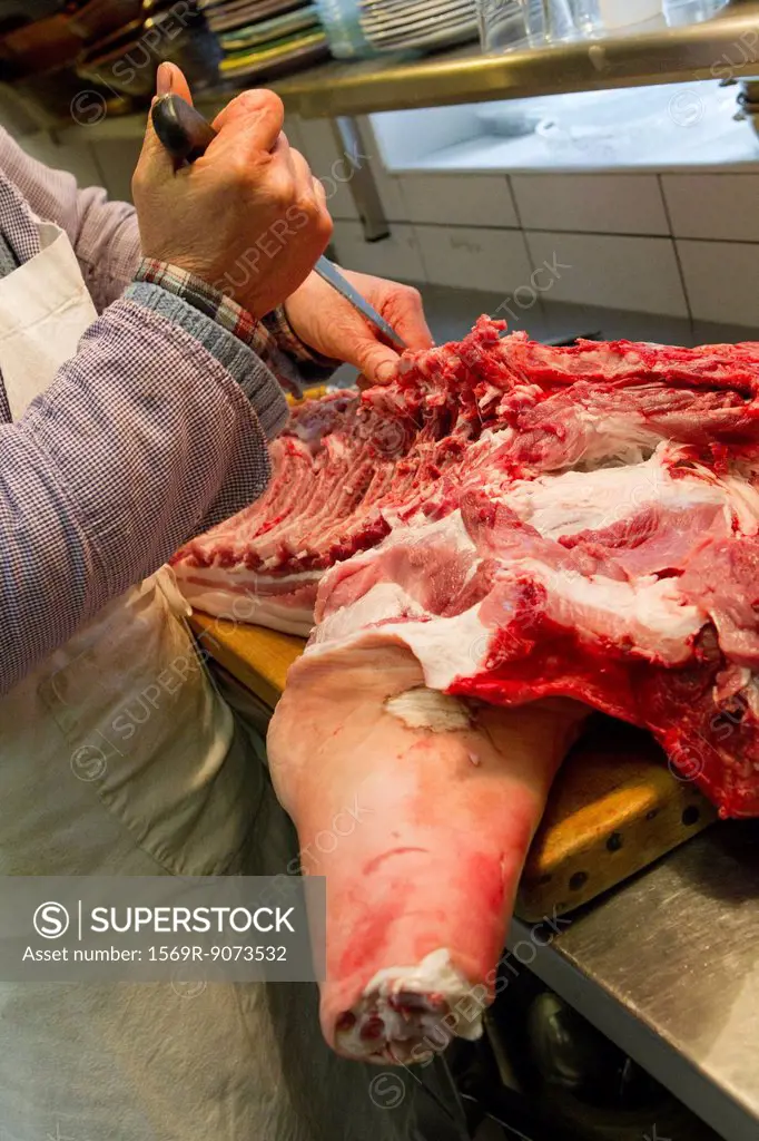 Butcher cutting pork