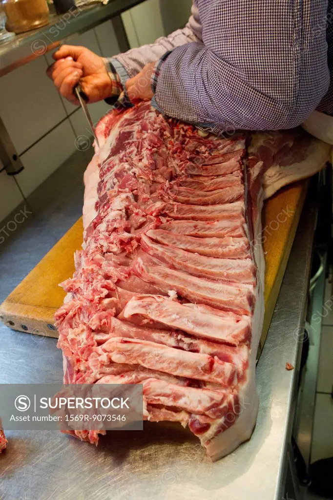 Butcher cutting pork