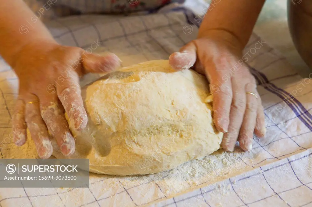 Woman´s hands kneading pastry dough
