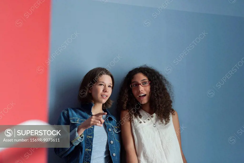 Young women gossiping together in hall