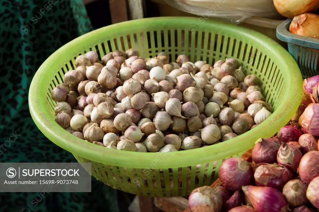 Basket of shallots on market stall