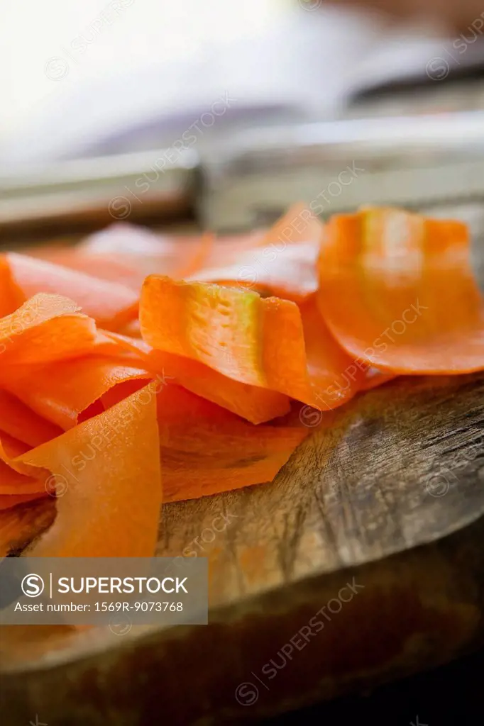 Thin slices of carrot on cutting board