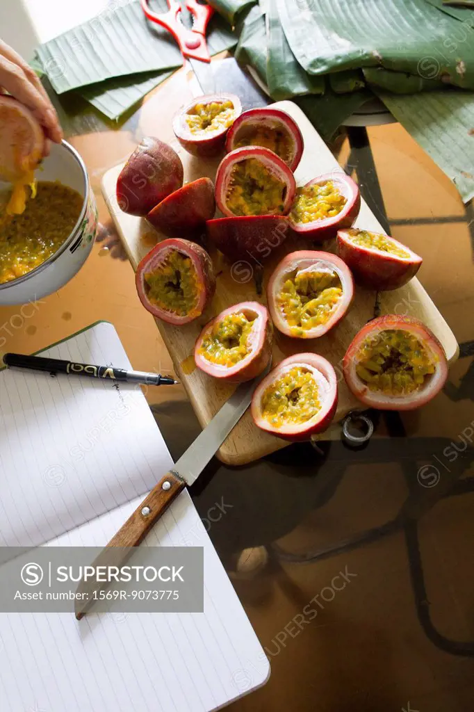 Halved passion fruits on cutting board