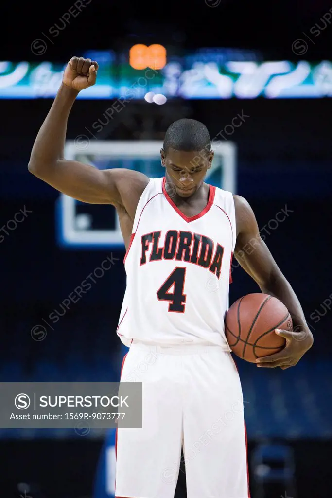 Basketball player cheering with arm raised, portrait