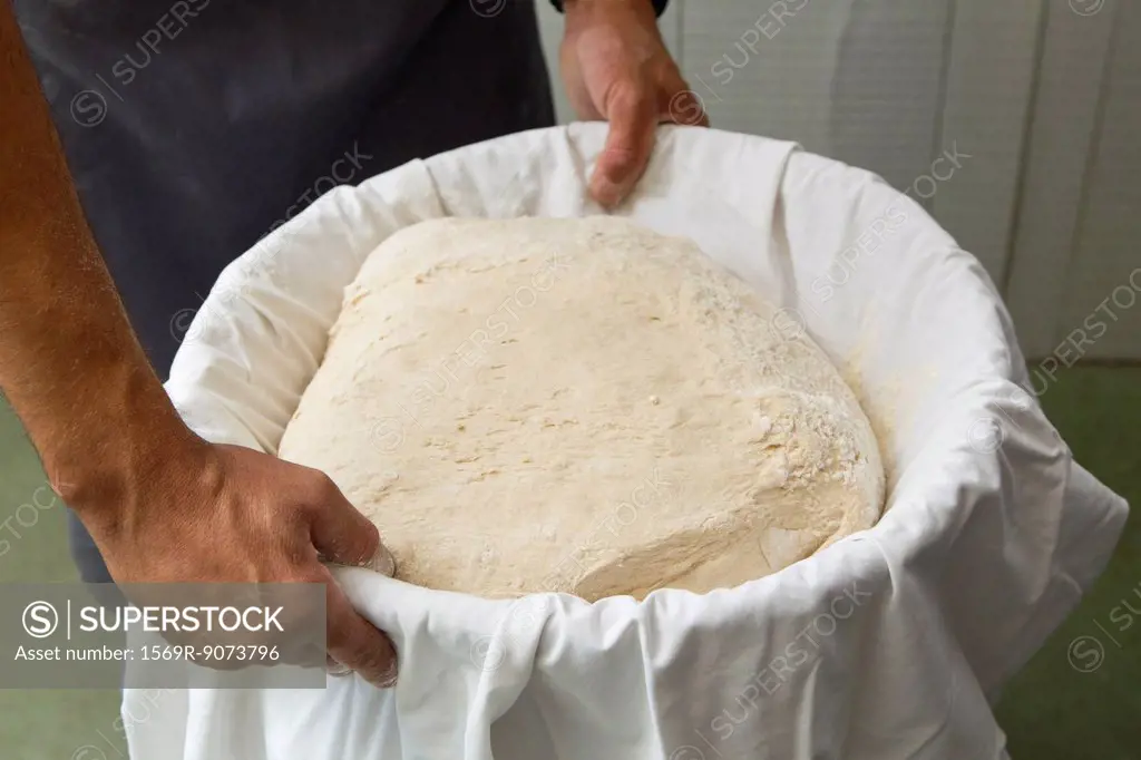 Preparing fresh bread dough, cropped