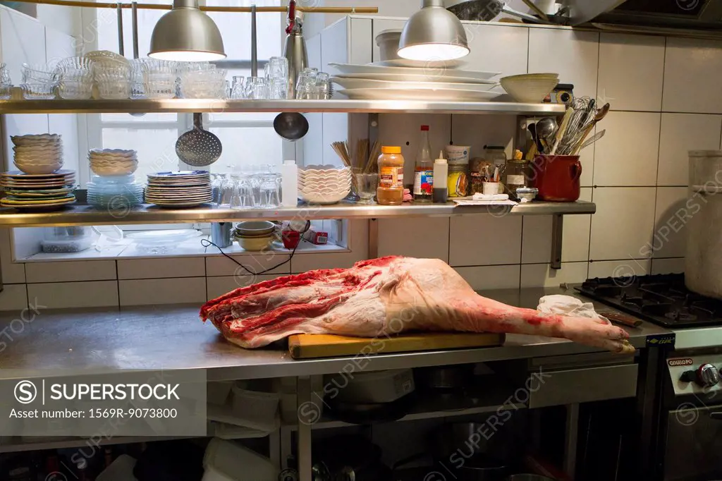 Pork leg on commercial kitchen counter