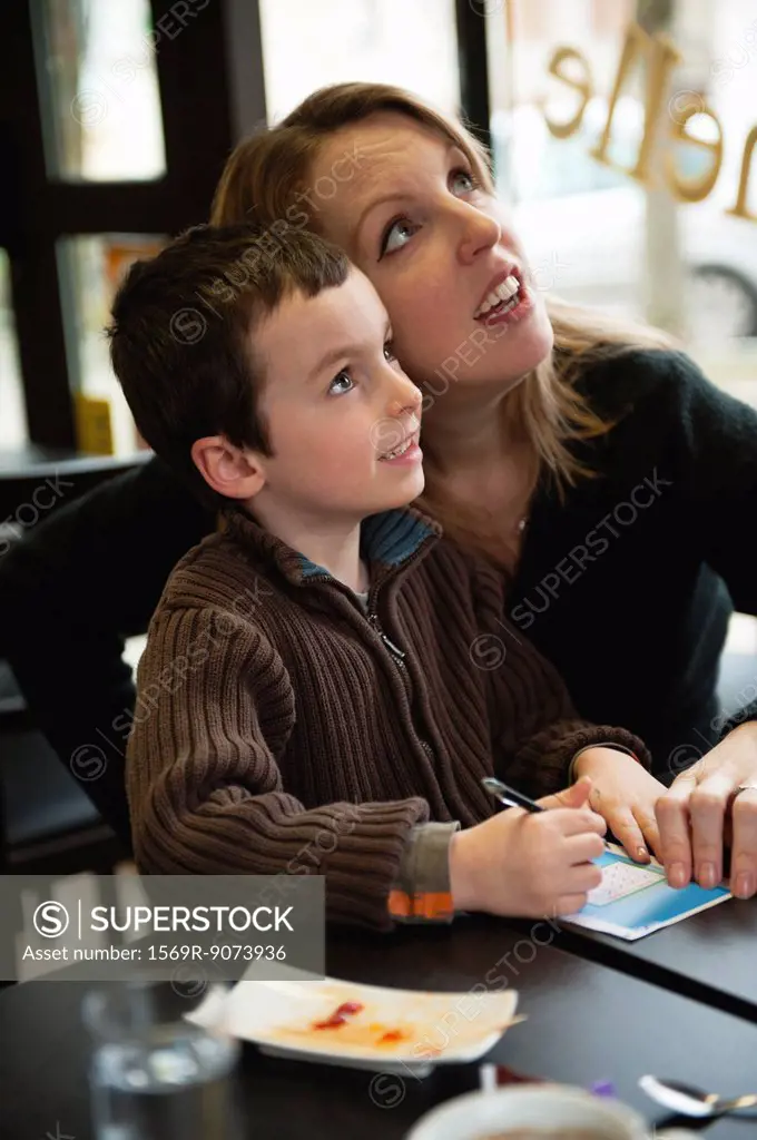 Mother and son checking results for lottery ticket