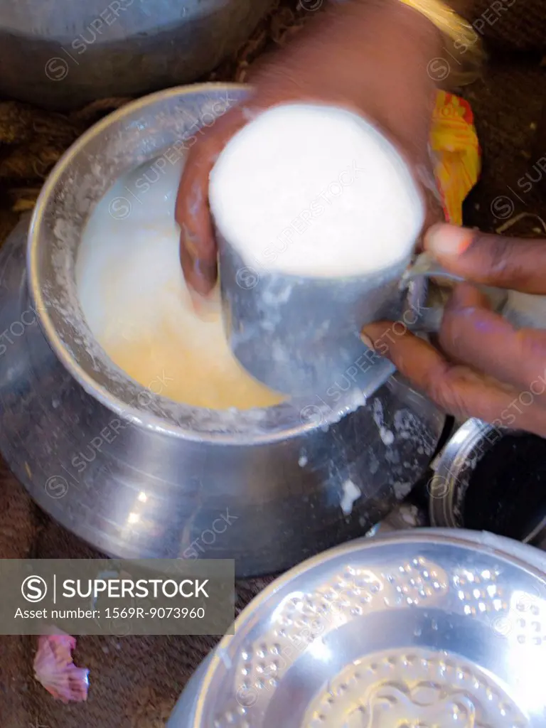 Person holding cup of lassi, blurred motion